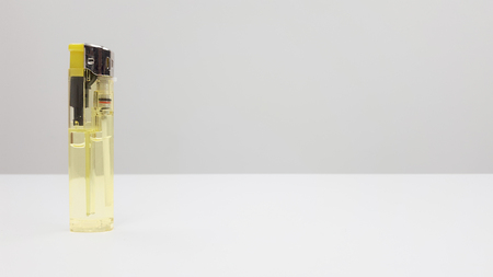 Disposable yellow gas lighters with isolated white backgroundの写真素材