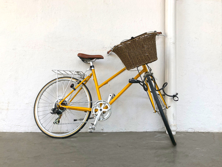 Retro bicycle leans against the wall
