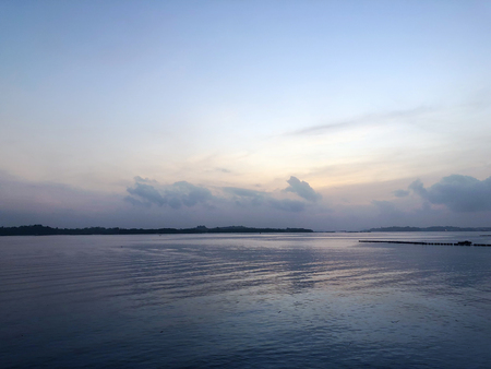 Calming sea view at dusk on a cloudy dayの写真素材