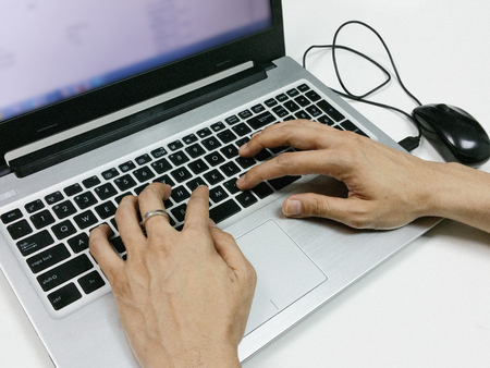 Typing on laptop, hands close-upの写真素材