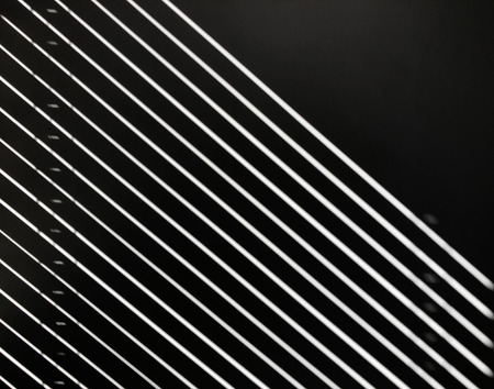 Light reflects against black wall, forming white lines. Abstract conceptの写真素材