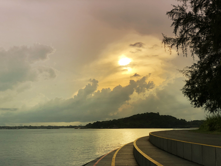 Sunset view at seaside with hill and wooden stepの写真素材
