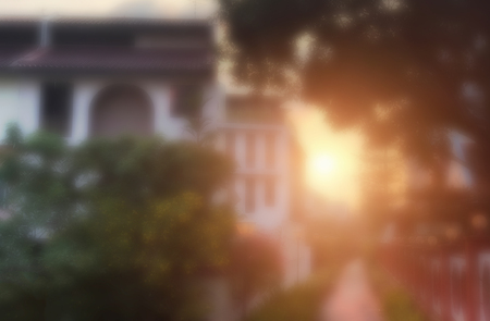 Blurred image/ Abstract of sunset/sunrise at landed houses with trees and plantsの写真素材