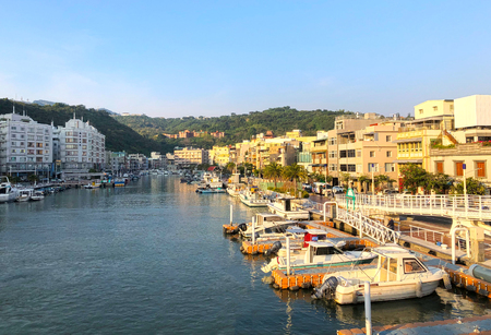 Boats docking on the pier with mountainous backgroundのeditorial素材