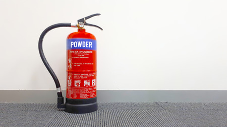Fire extinguisher on the floor lean against the wallのeditorial素材