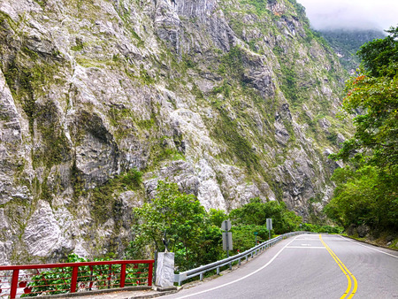 Mountain road with gigantic mountain wallの写真素材