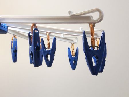 Focus view of laundry drying rack with blue clipsの写真素材