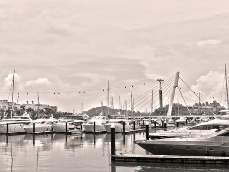 Monochrome/ sepia image of Luxury boats and yachts docked at berth, under cloudy skyのeditorial素材