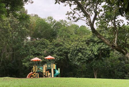 Distant view of colourful children playground in the greenery