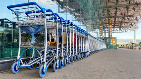 SINGAPORE, 4 APRIL 2020: Row of empty trolleys line up outside drop-off/pick-up point of Changi Airport Terminal 2.のeditorial素材