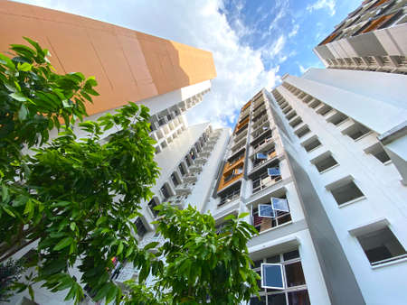 Worm's eye view of residential apartment under cloudy blue sky