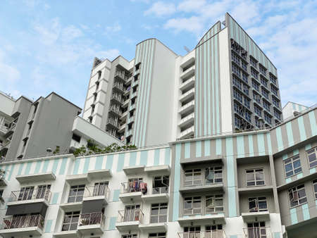 Modern Looking residential apartment (HDB) in Singapore under cloudy blue sky