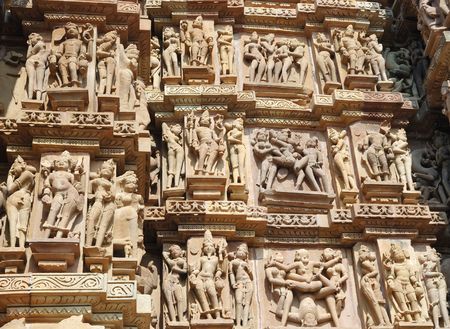 Famous kamasutra scenes on the wall of hindu temple in Khajuraho,Indiaの写真素材