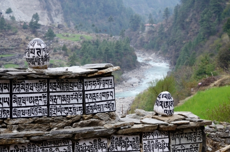 Buddhist mani stones with sacred mantras near Dudh Kosi river,Eastern Nepal, Everest region