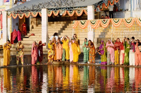 Pushkar,India,November 12,2013 - women perform puja - ritual ceremony at holy Pushkar Sarovar lake ,...