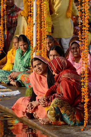 Pushkar,India,November 12,2013 - senior women perform puja - ritual ceremony at holy Pushkar Sarovar lake Pushkar -one of seven sacred cities in Indiaのeditorial素材