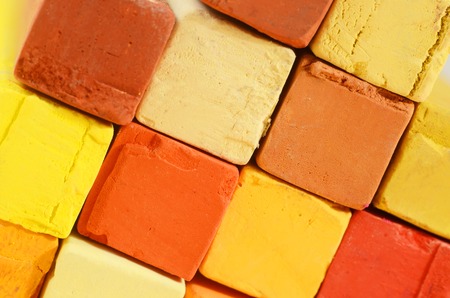 Creative art background - closeup of bright pastel crayons with yellow,orange,red and ochre coloursの写真素材