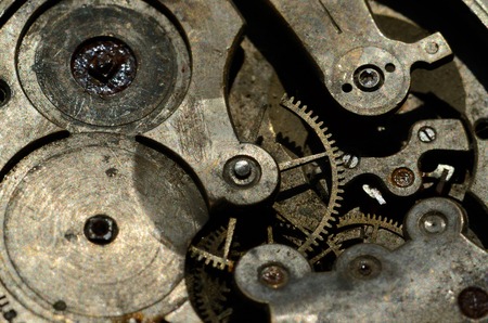 Closeup of cogweels in clockwork, grunge background for steampunk engineering designの写真素材