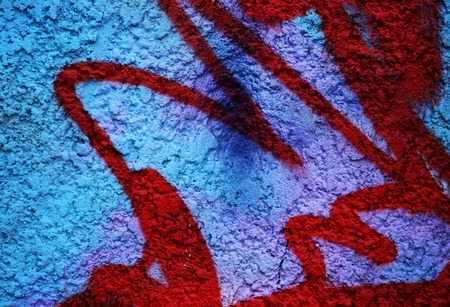 Dramatic grunge painted bright blue street wall with red stripes in abandoned city  area - creative background for your designの写真素材