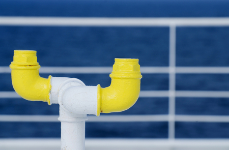 Nautical equipment of the ferry boat deck - yellow pipe and white railing on the backgroundの写真素材