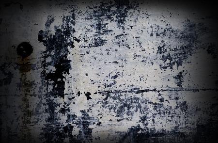 Dramatic grunge painted with white color wall with black splashes and scratches, background for...