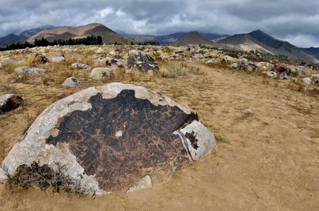 Ancient neolithic rock carvings depicting hunting ,Cholpon Ata, Issyk-Kul lake  shore,...