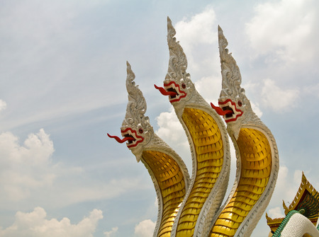 Three heads serpent below Buddha image.の写真素材