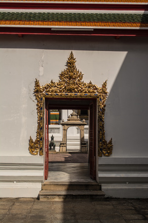 Door or entrance to Wat Pho Chinese and Thai Buddhist temple style in Bangkok, Thailand.の写真素材