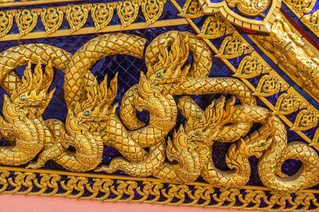 Thai art, carvings using gold color on the decorative plants on the royal ceremonies boatの写真素材