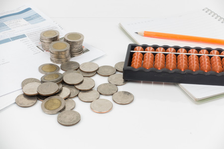 document monthly expenses of credit card have abacus , coins,pencil and notebook placed on white background.の写真素材