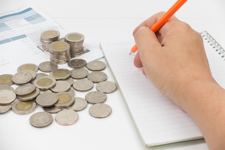 document monthly expenses of credit card have abacus , coins,pencil and notebook placed on white background.の写真素材