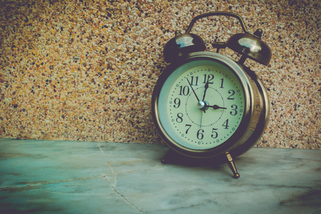Vintage clock in front of stone wall