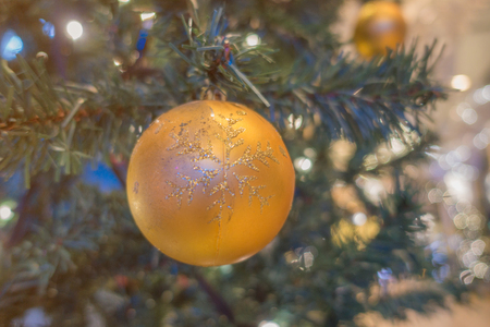 Orange ball decorated Christmas tree decorated with lights at night.の写真素材