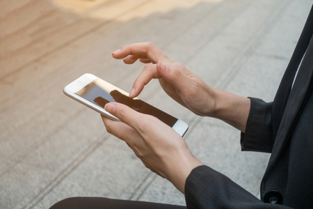Female using smartphone, focus on hands.の写真素材