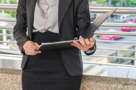 Focus your hand with the reporting of business women.の写真素材