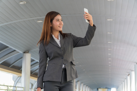 Beautiful woman Take selfie with a smart phone in hand.の写真素材