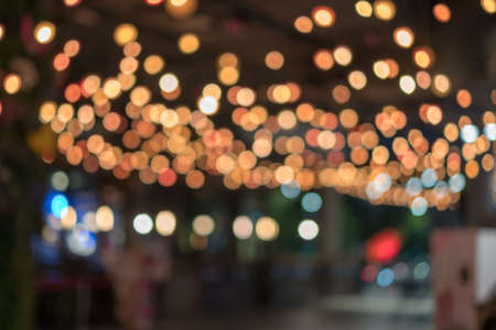 Multicolored defocused bokeh blurry lights. Abstract blur of red bokeh lighting for festival and celebration. Bokeh of light blub restaurants in shopping malls blurred backgroundの写真素材