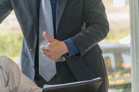 The hand that thumbs up to his colleagues in the concept of success.の写真素材