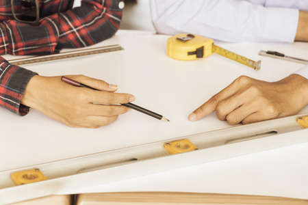 Focus Hands of engineers to consult with a colleague on the desk. The construction project.