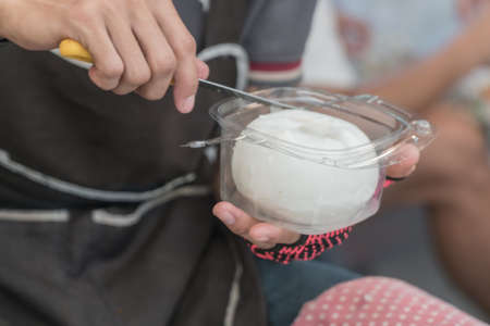 Close up The hands of man decorating coconut meat sale.の写真素材