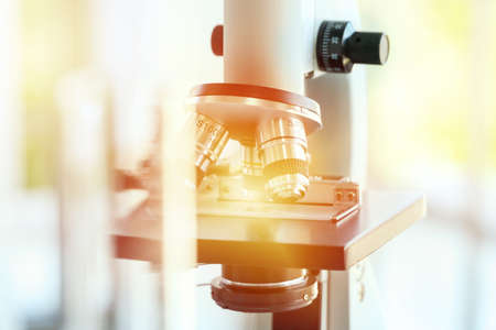 Microscope in laboratory medical background. Microscope for education or experiment chemistry biology test , examining liquid, medical equipment. Scientific and healthcare research concept.の写真素材