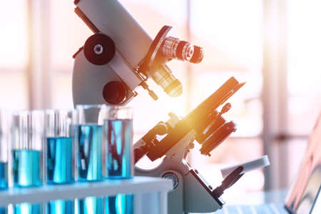 Microscope in laboratory medical background. Microscope for education or experiment chemistry biology test , examining liquid, medical equipment. Scientific and healthcare research concept.の写真素材
