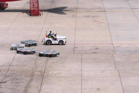 Bangkok Thailand-April 14,2019 Airport cargo and freight handling truck moving across the apron at Don Muang international airport in Bangkok Thailand.のeditorial素材