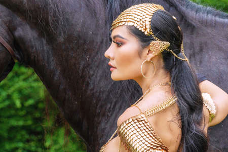 Face young woman wear fashion elf fantasy with horse background.の写真素材