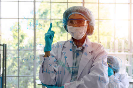 Laboratory science concept. Scientific young woman wear blue gloves and lab coat standing front...