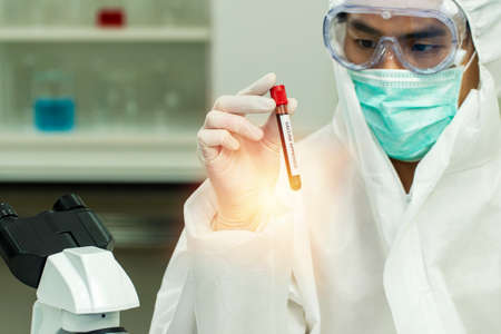 Research analyzing medicine concept. Scientist researcher or doctor man wear protection safety while...