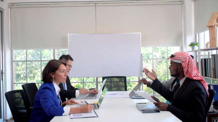 Group of business people partner talking deal project together at meeting room with whiteboard....