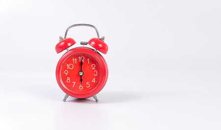 Red alarm-clock symbol time wake up over isolated white background. Analog red alarm clock on six oâclock morning waking vintage classic bell on white background.History, future, Countdown object timeの写真素材