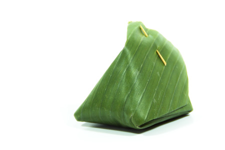 Sweet Sticky Rice with Coconut Custard Wrapped in Banana Leavesの写真素材