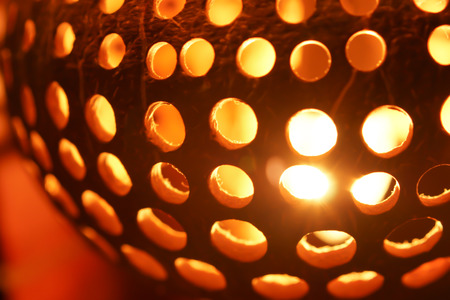 Closeup Carved and Perforated Coconut Lampの写真素材